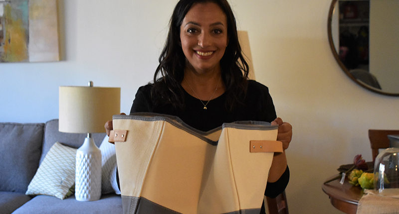 Interior designer Bon Abedeen holding fabric samples for Corporal Weber's home