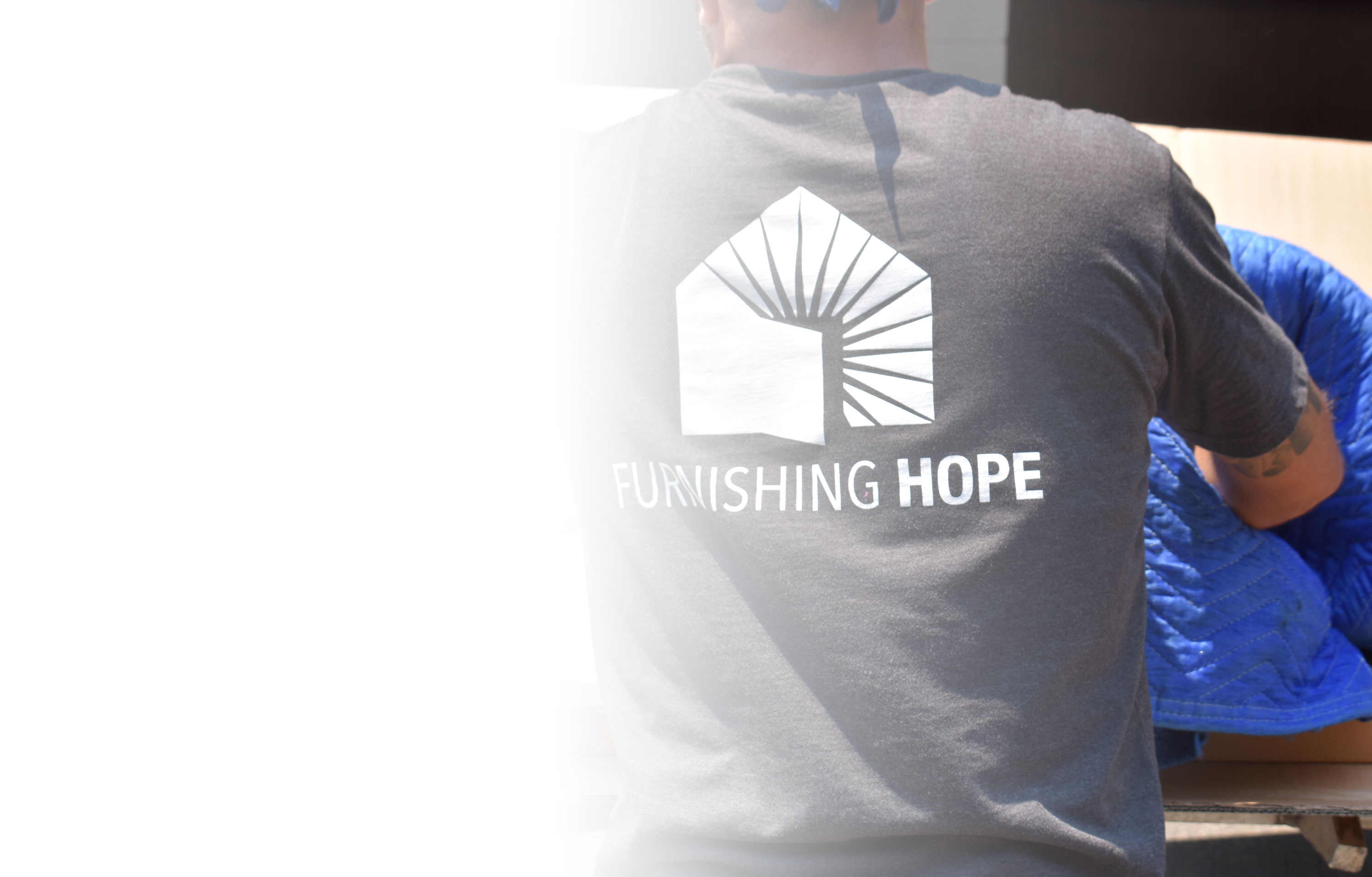 Furnishing Hope volunteer moving furniture