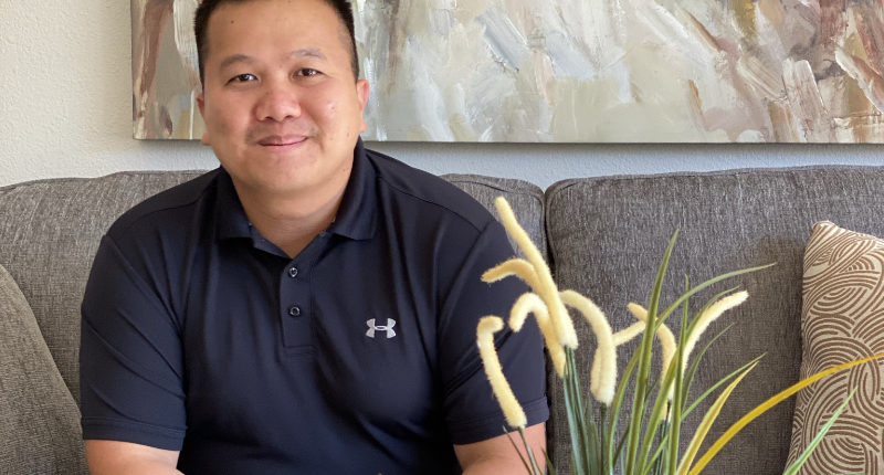 Sergeant Hai Nguyen sitting in his newly furnished home