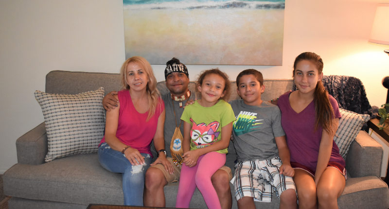 SPC David Tscherny and his family on their newly furnished sofa